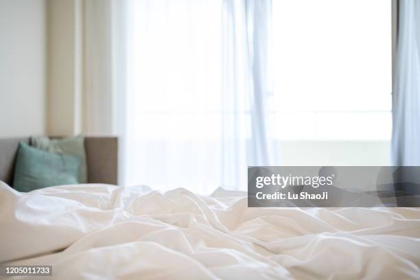 morning sunshine on the bed through the window - bedroom window foto e immagini stock