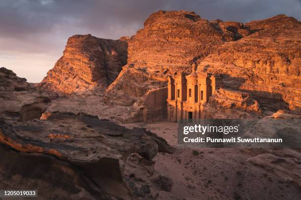 the monastery or ad deir at beautiful sunset in petra ruin and ancient city, jordan, arab - petra fotografías e imágenes de stock