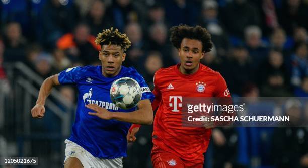 Bayern Munich's Dutch forward Joshua Zirkzee and Schalke's French defender Jean-Clair Todibo vie for the ball during the German Cup quarter-final...