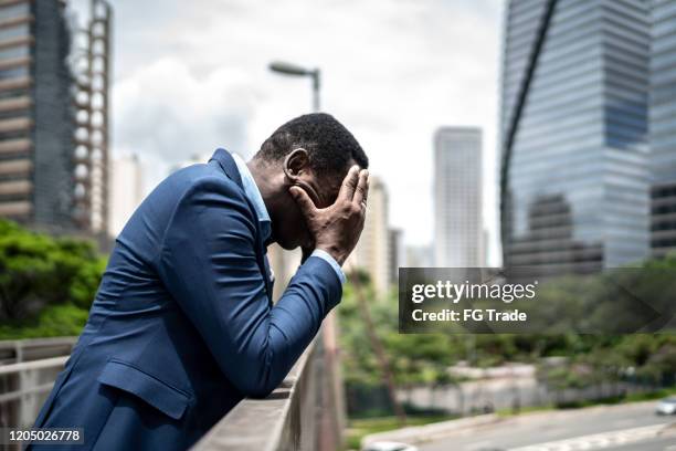 worried / hopelessness mature businessman at bridge - suicide stock pictures, royalty-free photos & images