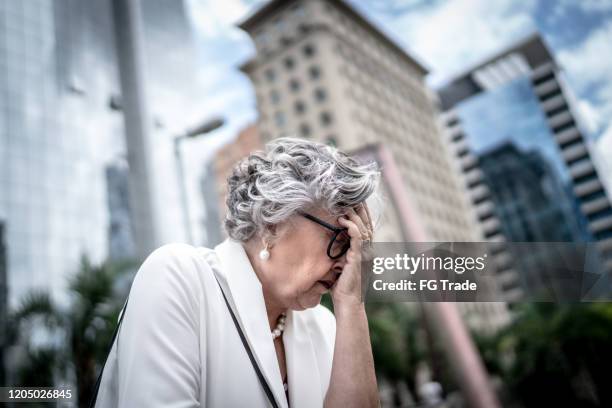 worried / hopelessness senior businesswoman at bridge - woman suicide stock pictures, royalty-free photos & images
