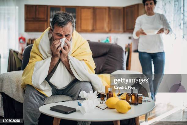 a sick man from a virus is at home - vitamin c stock pictures, royalty-free photos & images