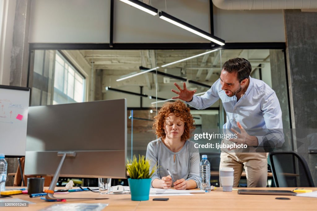 Boss threatening his employee in office