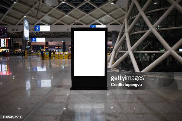 blank billboard at airport - station stock-fotos und bilder