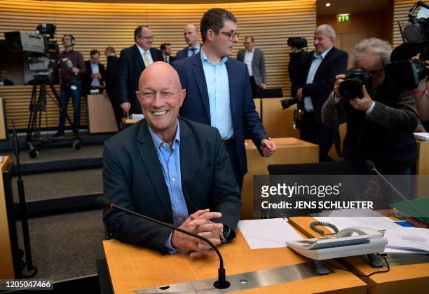 Thomas Kemmerich from the free democratic FDP party smiles as he has taken seat at the Thuringian State Parliament in Erfurt, eastern Germany, on...