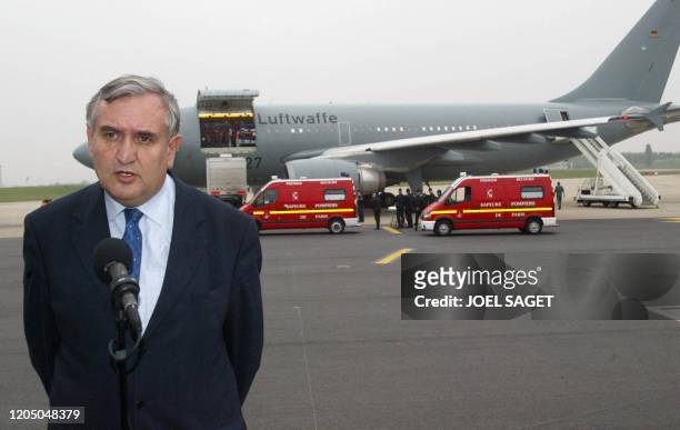 Le Premier ministre Jean-Pierre Raffarin s'adresse aux journalistes, le 09 mai 2002 à l'aéroport d'Orly, après l'arrivée des 12 blessés français de...