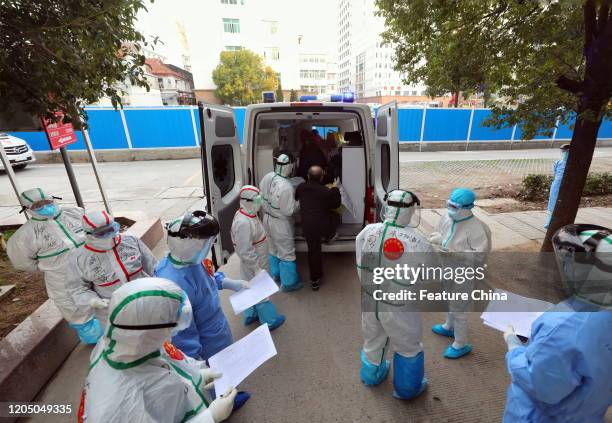 Medical workers prepare to transfer Covid-19 patients from the No.3 Hospital to Huoshenshan Hospital in Wuhan in central China's Hubei province...