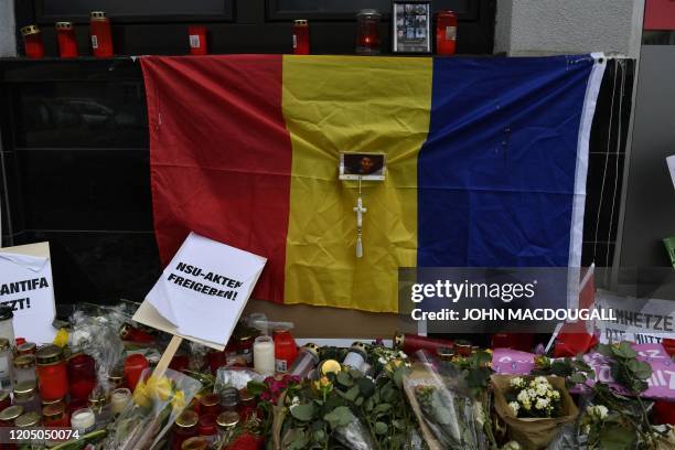 Flowers, candles and a Romanian flag are pictured in Hanau, near Frankfurt, western Germany, on March 4 in front of the shisha bar that was targeted...