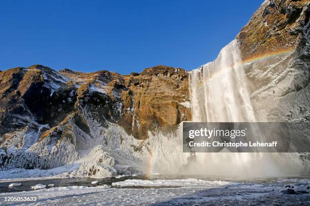 the skogafoss waterfalls in iceland, during winter - skogafoss waterfall stock pictures, royalty-free photos & images