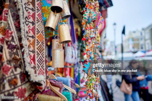 colourful asian ornaments hanging outside a shop on portobello road - portobello stock pictures, royalty-free photos & images