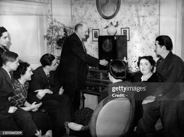Members of family of the new elected President Albert Lebrun listen to a radio during the announcement of the results of the presidential election on...