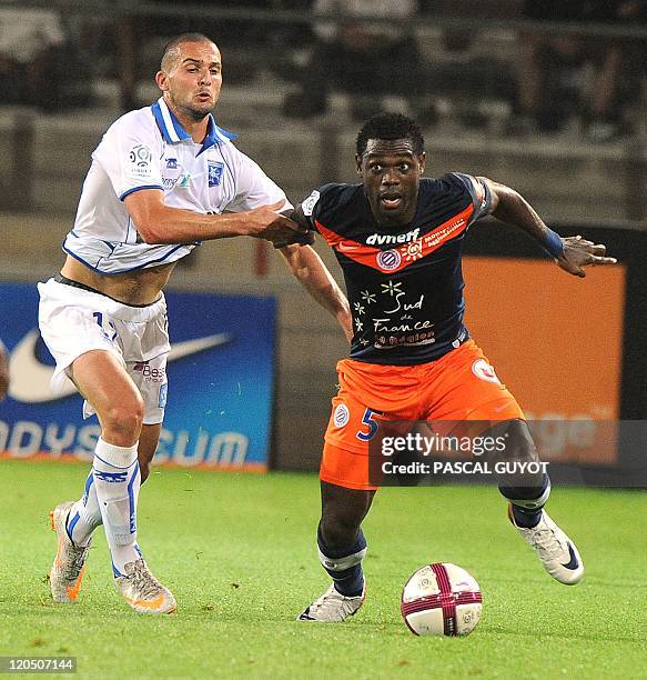 Montpellier's Defender Henri Bedimo vies with Auxerre's Forward Ben Sahar during the French L1 football match Montpellier vs Auxerre, on August 06th,...