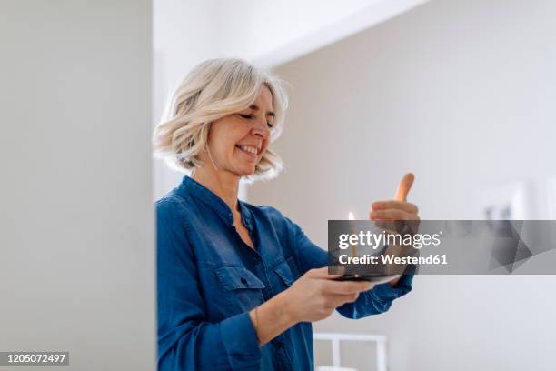 happy mature woman with birthday cake at home - older woman birthday stock pictures, royalty-free photos & images