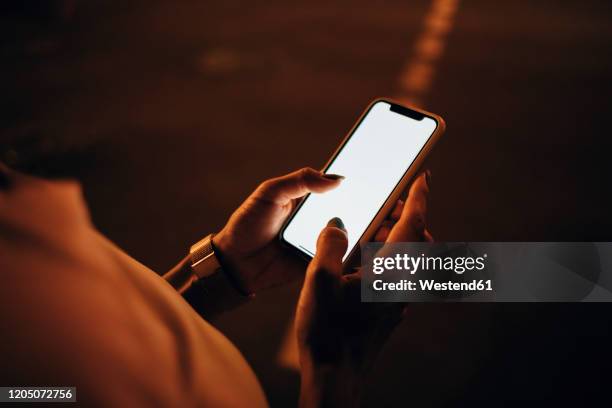 hands of woman holding smartphone at night, close-up - ukraine people stock pictures, royalty-free photos & images