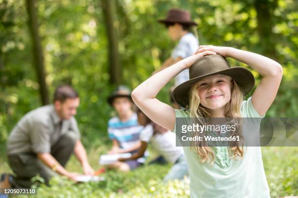 little girl scout win the forest with her group, portrait - portrait of school children and female teacher in field stock pictures, royalty-free photos & images