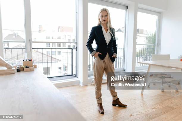 portrait of a confident young businesswoman in office - arrogant stock-fotos und bilder