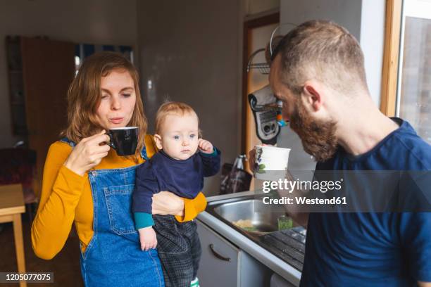 family in the kitchen at home - baby cup fotografías e imágenes de stock