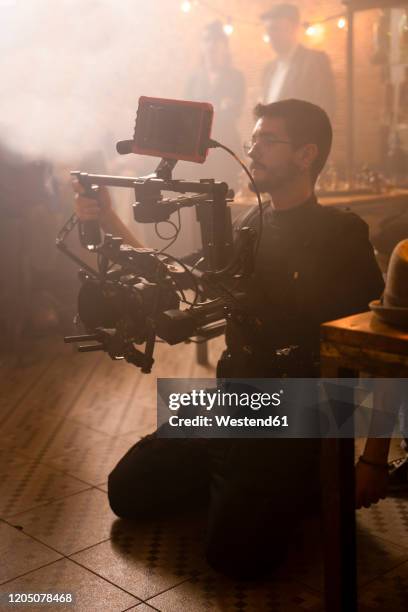 cameraman at work on movie set - film set lighting stock pictures, royalty-free photos & images