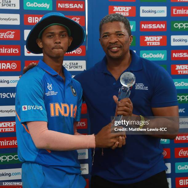 Yashasvi Jaiswal of India is presented with the 'Player of the Tournament' award from former South African cricketer Makhaya Ntini during the ICC U19...