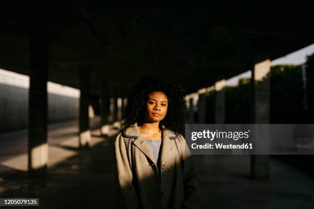 portrait of a young woman in a parking garage - portrait shadow stock pictures, royalty-free photos & images