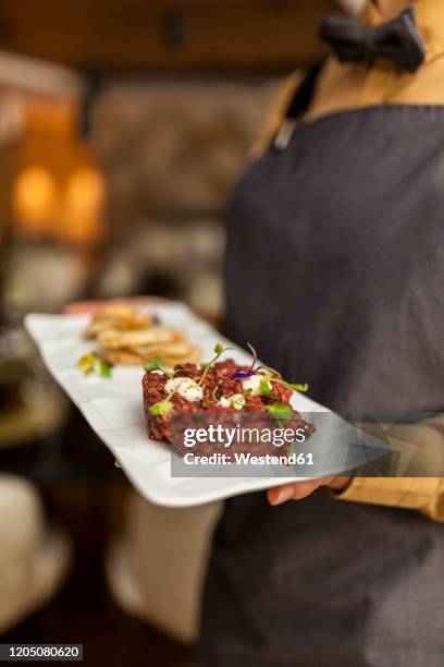 waitress serving steak tartar on white plate - biff tartar bildbanksfoton och bilder