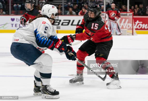 Melodie Daoust of Canada shoots the puck past Megan Bozek of the United States during women's hockey action in Game of the 2020 Rivalry Series at...