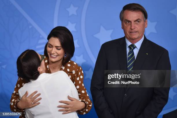 Alongside President Jair Bolsonaro and First Lady Michelle Bolsonaro, famous Brazilian novel actress, Regina Duarte, reacts during her inauguration...