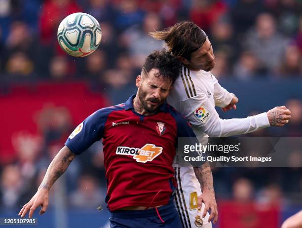 Ruben Garcia of CA Osasuna battle for the ball with Sergio Ramos of Real Madrid CF during the Liga match between CA Osasuna and Real Madrid CF at El...
