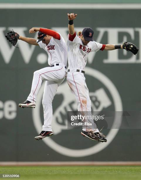Jacoby Ellsbury of the Boston Red Sox and Josh Reddick celebrate the win over the New York Yankees on August 6, 2011 at Fenway Park in Boston,...
