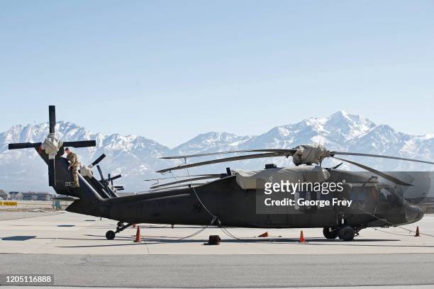 Maintenance worker look over the rotor assembly of an UH-60 Black Hawk helicopter on March 4, 2020 in Kearns, Utah. This Utah National Guard facility...