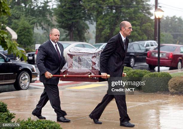 Pall bearers walk the remains of Lauren Giddings into her funeral service at St. Mary of the Mills Catholic Church in Laurel, Maryland, Saturday,...