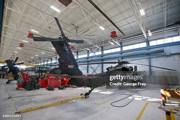 Maintenance workers perform repairs on an UH-60 Black Hawk helicopter on March 4, 2020 in Kearns, Utah. This Utah National Guard facility repairs and...