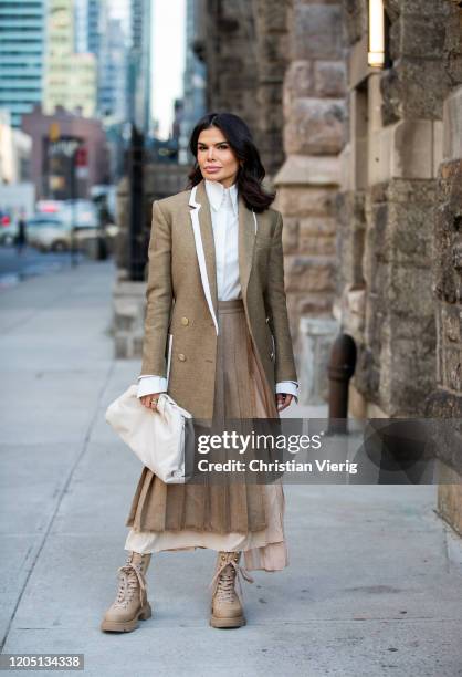 Victoria Barbara is seen wearing Fendi blazer, white Givenchy blouse, Max Mara pleated skirt, white Bottega bag, boots by Prada during New York...