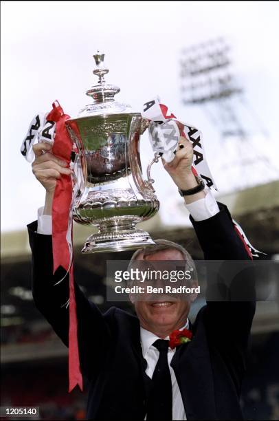 Alex Ferguson the manager of Manchester United celebrates with the trophy after the AXA FA Cup Final match against Newcastle United played at Wembley...