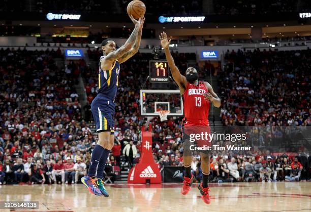 Jordan Clarkson of the Utah Jazz shoots the ball while defended by James Harden of the Houston Rockets in the first half at Toyota Center on February...