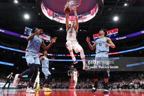 Moritz Wagner of the Washington Wizards dunks in front of Jaren Jackson Jr. #13 of the Memphis Grizzlies during the second half at Capital One Arena...