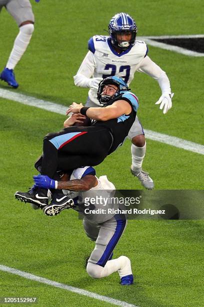 Philip Nelson of the Dallas Renegades gets upended by Dexter McCoil of the St. Louis Battlehawks in the third quarter at an XFL Game on February 09,...