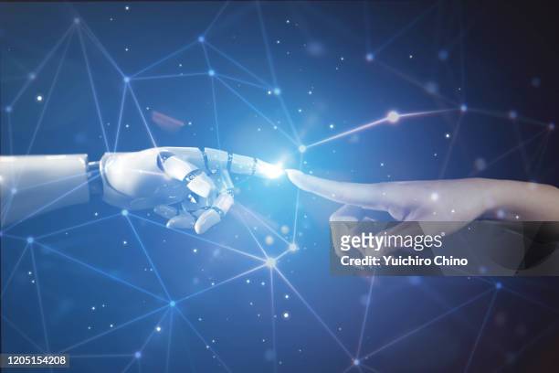 woman touching robot finger - human finger stock pictures, royalty-free photos & images