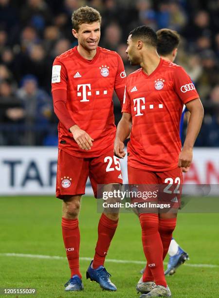 Thomas Mueller of Bayern Muenchen and Serge Gnabry of Bayern Muenchen speaks with during the DFB Cup quarterfinal match between FC Schalke 04 and FC...