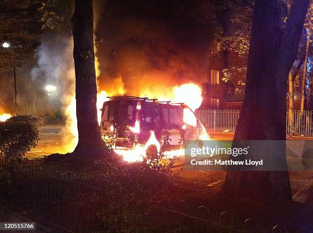 Van burns as youths riot after a protest against the killing of a man by armed police in an attempted arrest, August 6, 2011 in London, England....