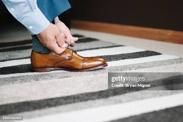 man ties shoe - mens dress shoes stock pictures, royalty-free photos & images