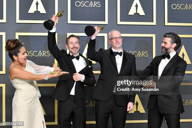 Sound editors Mark Taylor and Stuart Wilson, winners of the Sound Mixing award for “1917,” pose with Salma Hayek and Oscar Isaac in the press room...