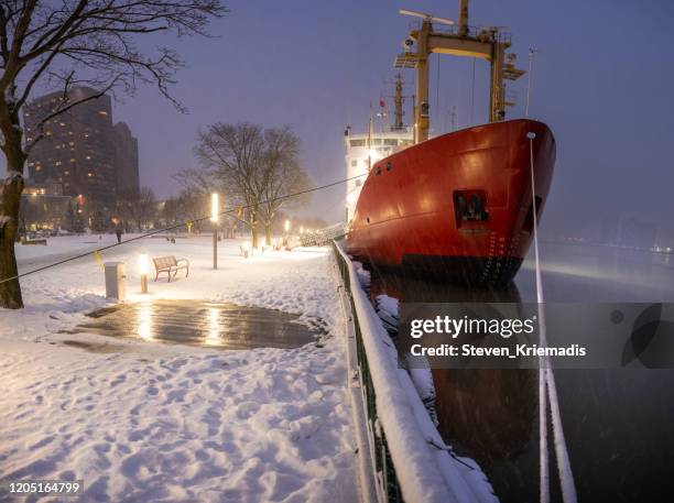 windsor, ontario - winter skyline with coast guard ship moored - windsor ontario stock pictures, royalty-free photos & images