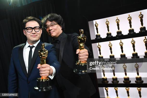 In this handout photo provided by A.M.P.A.S. Best Original Screenplay award winners Han Jin Won and Bong Joon Ho pose backstage during the 92nd...