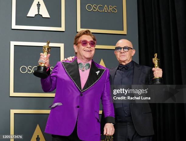 Elton John and Bernie Taupin, winners of Best Original Song for " Love Me Again, 'Rocketman'", pose in the press room during 92nd Annual Academy...