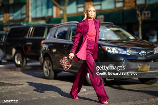 Leonie Hanne wears a purple lustrous silky oversized blazer jacket, a pink striped top, flared pants, pink sandals, a Christian Dior mini tote bag,...