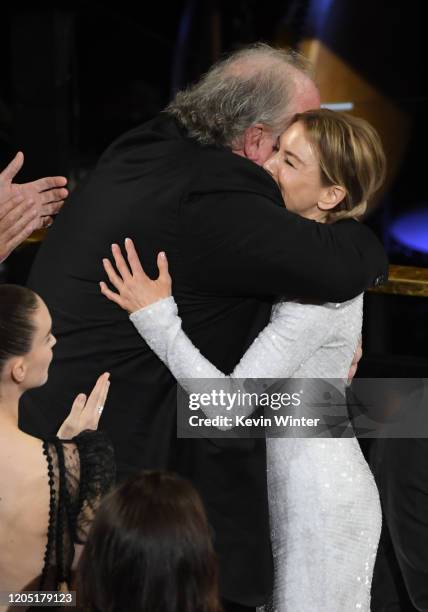 John Carrabino and Renée Zellweger react after Ms. Zellweger was named winner of the the Actress in a Leading Role award for 'Judy' during the 92nd...