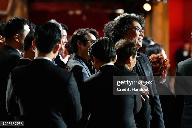 In this handout photo provided by A.M.P.A.S. Best Picture Award winners for "Parasite" pose onstage during the 92nd Annual Academy Awards at the...