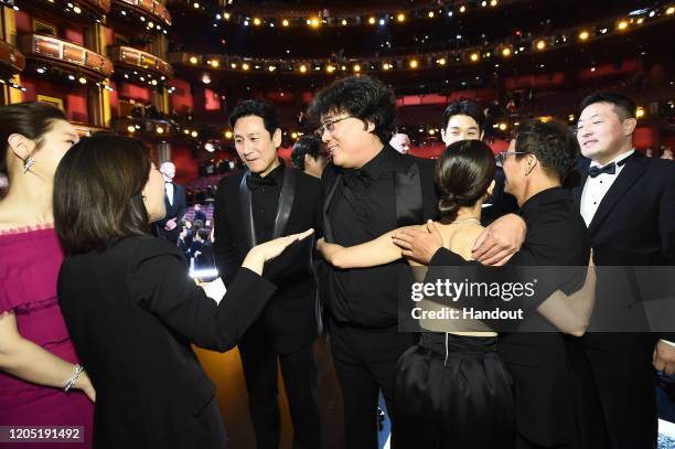 In this handout photo provided by A.M.P.A.S. Best Picture Award winners for "Parasite" pose onstage during the 92nd Annual Academy Awards at the...