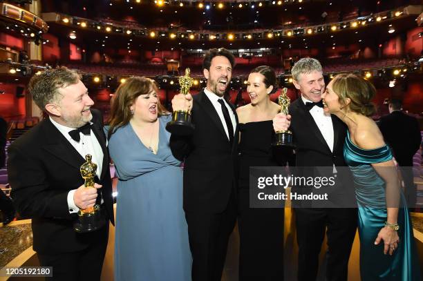 In this handout photo provided by A.M.P.A.S. Visual Effects award winners Greg Butler, Guillaume Rocheron, and Dominic Tuohy pose onstage during the...